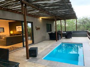 a swimming pool in the middle of a patio at Kruger Willows in Marloth Park