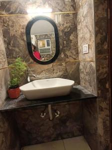 a bathroom with a sink and a mirror at Tea Estate view stay in Ooty