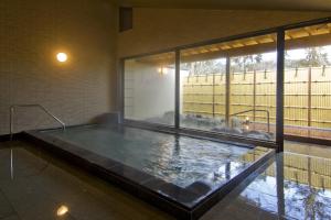 a large aquarium in a room with a large window at Nikko Tokanso in Nikko