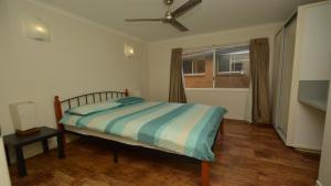 a bedroom with a bed and a window at Unit 2 5 Pilot St Yamba in Yamba