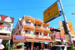 a large building with a sign in front of it at Thaveesinh Hotel in Ban Houayxay