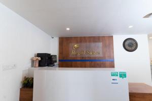 a sign for a hotel suites on top of a refrigerator at Regal Suites in Bengaluru