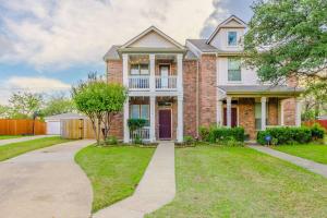 a large brick house with a driveway at Cozy 2BD/3BA with Balcony/Patio/Free Parking/Fast Wifi! 5min to Downtown Plano! in Plano