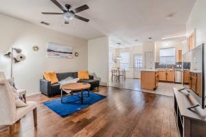 a living room with a couch and a table at Cozy 2BD/3BA with Balcony/Patio/Free Parking/Fast Wifi! 5min to Downtown Plano! in Plano