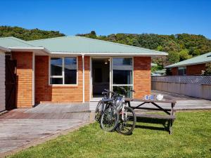 two bikes parked on a bench in front of a house at Torquay Central - Kaikoura Holiday Home in Kaikoura