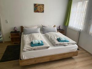 a bedroom with a bed with two towels on it at Bett & Bike Hansehof in Salzwedel
