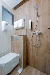 a bathroom with a shower with a toilet and a sink at Hotel 81 Premier Star in Singapore