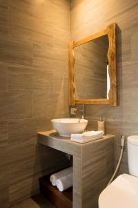 a bathroom with a sink and a mirror at Divara Ubud in Ubud