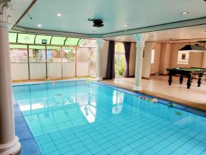 an indoor swimming pool with a pool table at The Park Pool Villa Pattaya in Pattaya Central