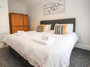 a bedroom with a large bed with towels on it at 37 Nutter Road in Cleveleys +14 photos