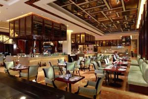 a restaurant with tables and chairs and a bar at Wyndham Grand Plaza Royale Palace Chengdu in Chengdu