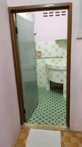 a bathroom with a glass shower and a sink at JSW Inn in Gelugor