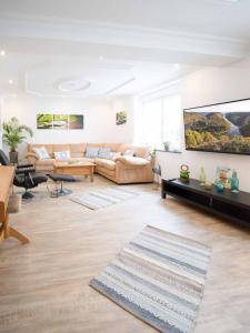 a living room with a couch and a tv at Ferienhaus Müller in Merzig