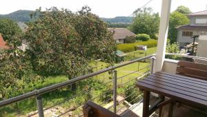 a porch with a wooden bench on a balcony at Ferienhaus Müller in Merzig