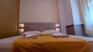Postelja oz. postelje v sobi nastanitve Hotel Syariah Larismanis