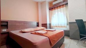 Postelja oz. postelje v sobi nastanitve Hotel Syariah Larismanis