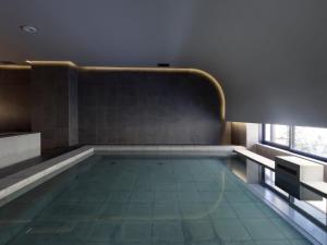 a swimming pool in a room with a window at SOKI KANAZAWA 19th November 2022 OPEN in Kanazawa