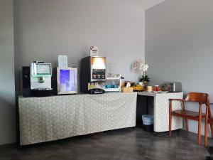 a counter in a room with a desk with a microwave at Atom Phuket Hotel -SHA Plus in Nai Yang Beach