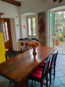 a wooden table in a kitchen with chairs around it at CASA VACANZE "LA QUIETE" in Nonio