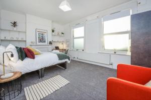 a bedroom with a bed and two windows at Private Room in a Shared Accommodation in Norwood