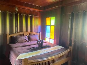 um quarto com uma cama com uma cobra em บ้านสวนเปรมณัฐตรา em Ban Song (1)