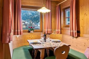 a table and chairs in a room with a window at Cesa Valeria App Monika in Ortisei