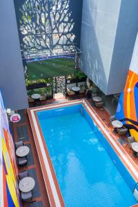 a large swimming pool with chairs and a table at Monty Suites Lekki in Lagos