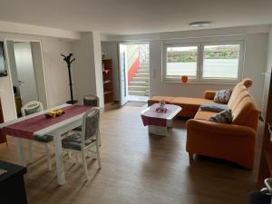 a living room with a couch and a table at Ferienwohnung im Grünen in Lebach