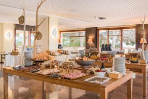 a buffet of food on a table in a restaurant at Almadraba Park Hotel in Roses