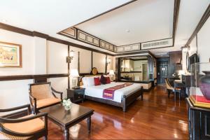 a hotel room with a bed and a living room at Wora Bura Hua Hin Resort & Spa - SHA Extra Plus in Hua Hin