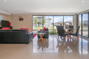 a living room with a couch and chairs and a table at Ocean View Executive Apartment 2 in Busselton