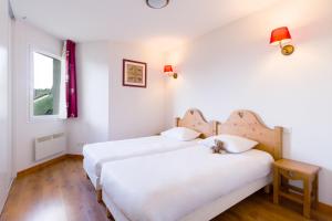 Кровать или кровати в номере Garden & City Evian - Lugrin