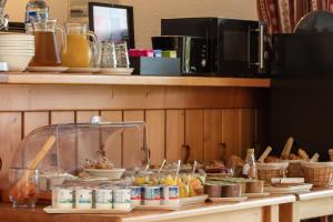 a buffet of food on a counter in a restaurant at Garden & City Evian - Lugrin in Lugrin