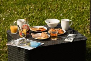 a picnic table with plates of food and drinks on it at Garden & City Evian - Lugrin in Lugrin +93 photos