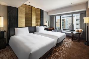 Postel nebo postele na pokoji v ubytování Hyatt Regency Yokohama