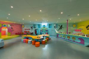 a childrens play room with a slide and a playground at Riviera by Isrotel Collection in Eilat