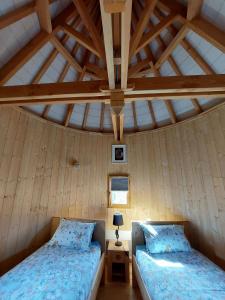 a bedroom with two beds in a room at Roulottes au pied du Vercors in Saint-Jean-en-Royans
