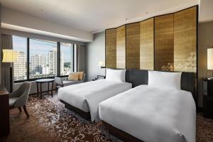 Postel nebo postele na pokoji v ubytování Hyatt Regency Yokohama