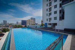 a large swimming pool on the roof of a building at Avatel Jelutong in George Town