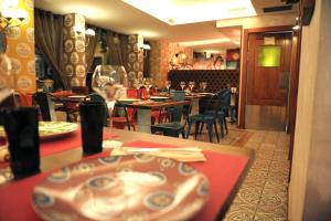 restauracja ze stołami i krzesłami oraz talerzem na stole w obiekcie Le Petit León w mieście León