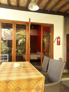 Pondok IJo Villa في Timuran: طاولة وكراسي مع طاولة وغرفة