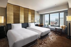 Postel nebo postele na pokoji v ubytování Hyatt Regency Yokohama