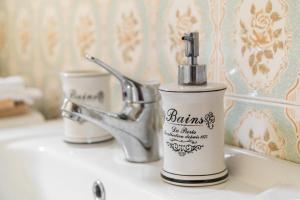 a soap dispenser sitting on a sink in a bathroom at Apartma Ivana & Ivanka in Bohinj +26 photos