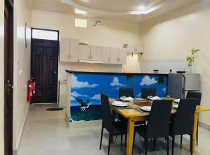 a dining room with a table and chairs in a kitchen at LETS GO HURAA in Huraa +4 photos