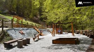 a park with a playground with slides and swings at Mavrovo ski apartment in Mavrovo