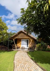 a house with a brick walkway in front of it at AATHAVAN MATICHI ECO RESORT in Panhāla