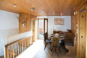 a dining room with a wooden table and chairs at Large alpine house for 10 with panoramic view in Schmitten