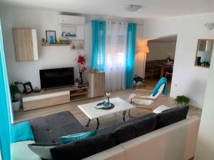 a living room with a couch and a tv at Apartment in Bribir 15452 in Bribir
