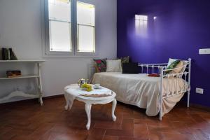 a bedroom with a bed and a table and a window at Corte Cantoni in Nonantola