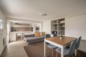 a living room with a table and a couch at Ales Green in Camorino +20 photos